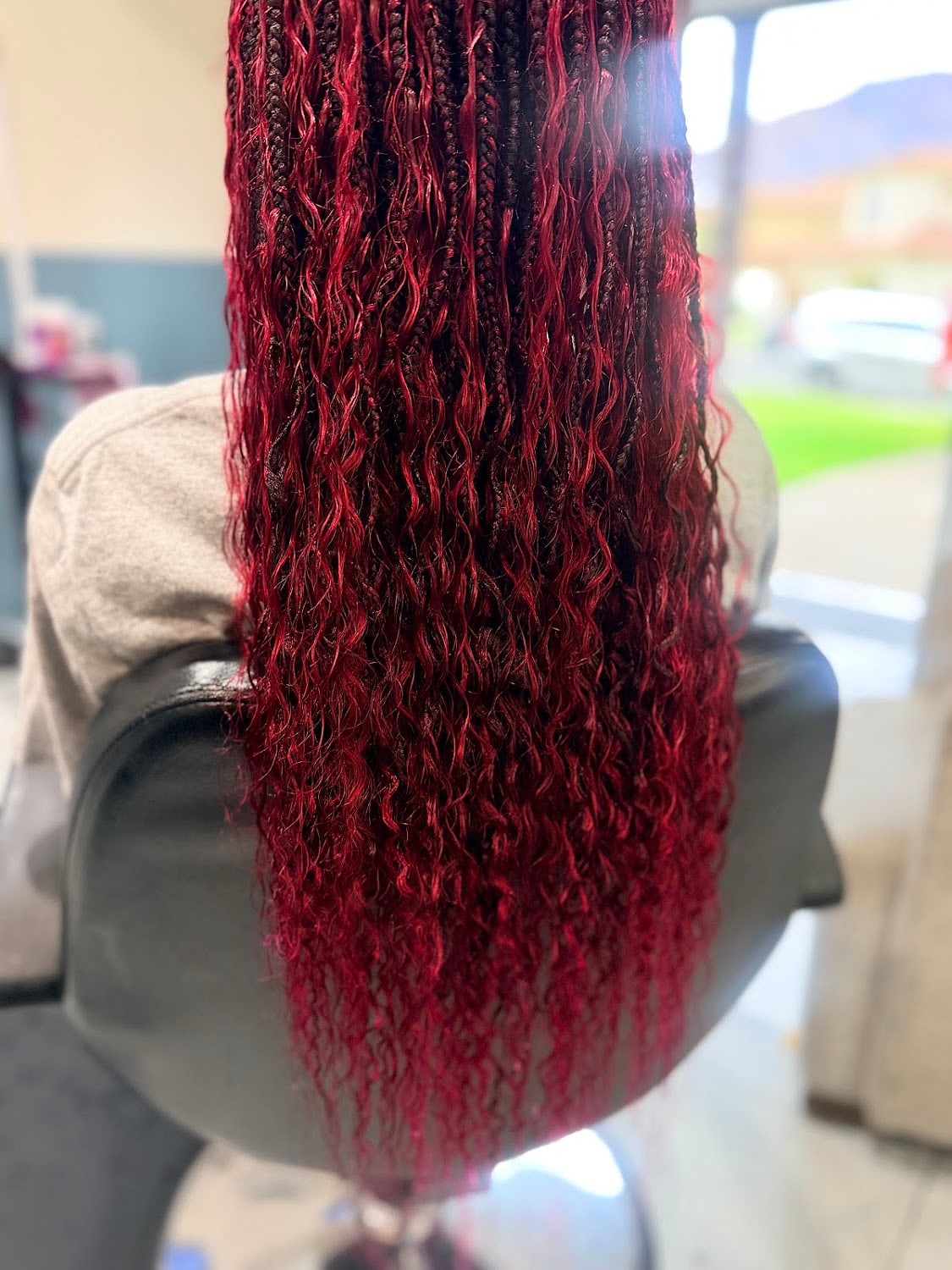 Long burgundy braids with a loose wave