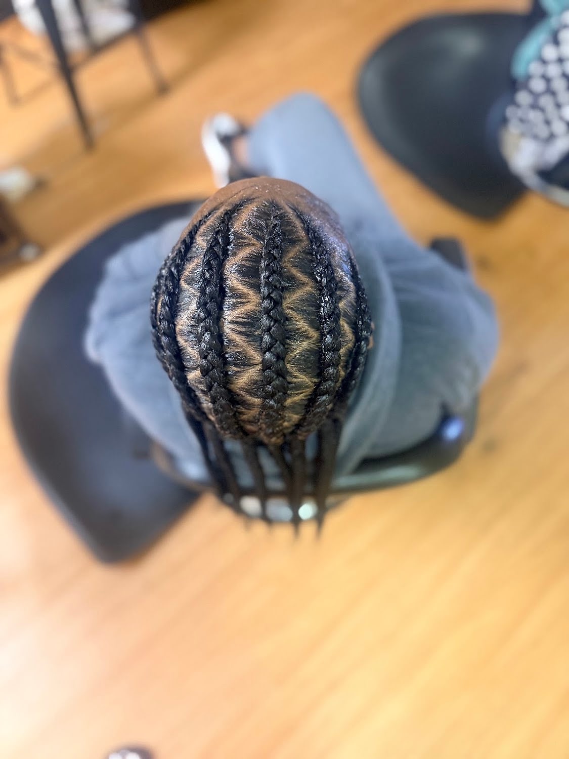Cornrows braided in a curved pattern, seen from above