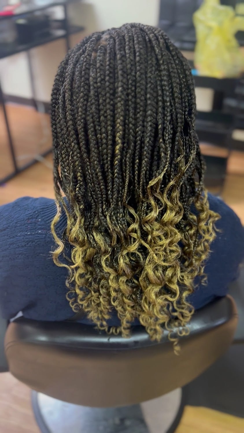 Long braids fading from dark to blonde with curled ends