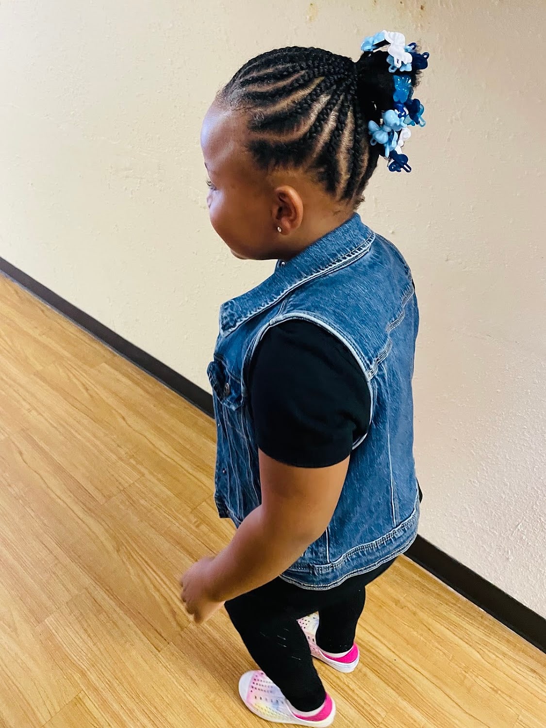 A child's braids finished with beads